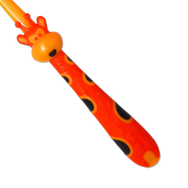 Children's manual toothbrush. Close up of giraffe design, orange and yellow.